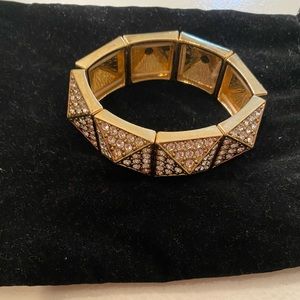 Gold bangle with diamonds.